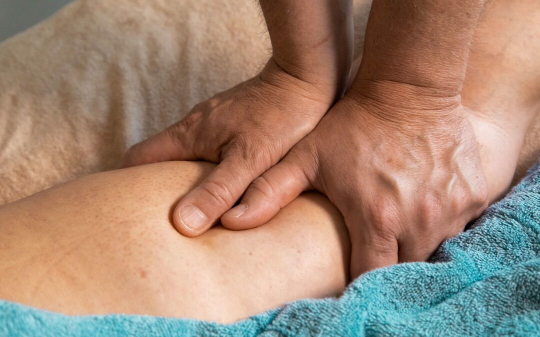 A woman receiving a Sports Massage Therapy on her back to enhance athletic performance.